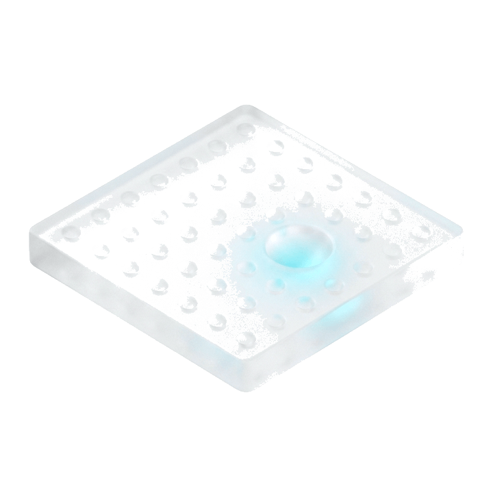 A field of identical glass dimples with one lit from below — the single opportunity worth taking
